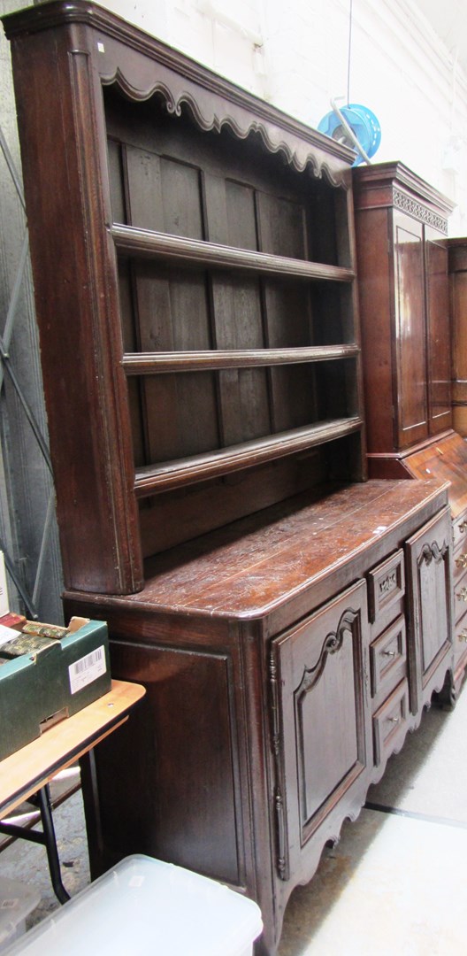 Appraisal: A French th century oak dresser the enclosed three tier