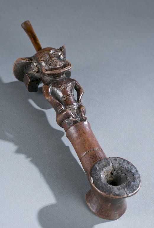 Appraisal: Pipe with a seated figure th th c A pipe