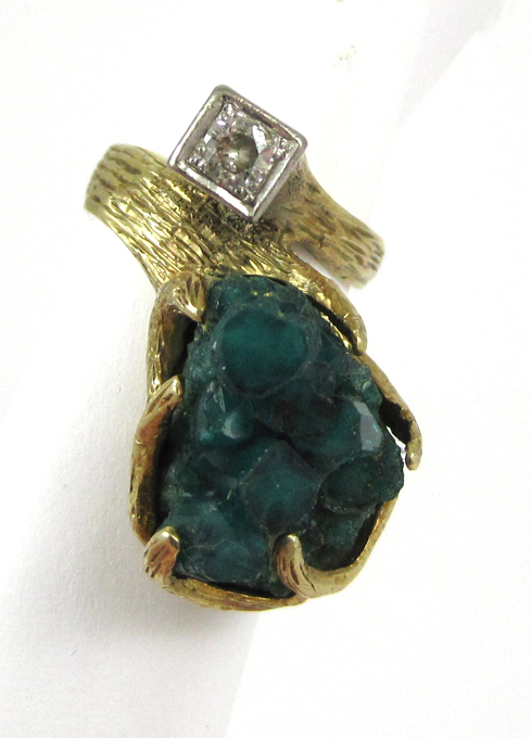 Appraisal: EMERALD AND FOURTEEN KARAT GOLD RING set with rough emerald