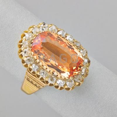 Appraisal: IMPERIAL TOPAZ AND DIAMOND K GOLD RING Oval faceted topaz