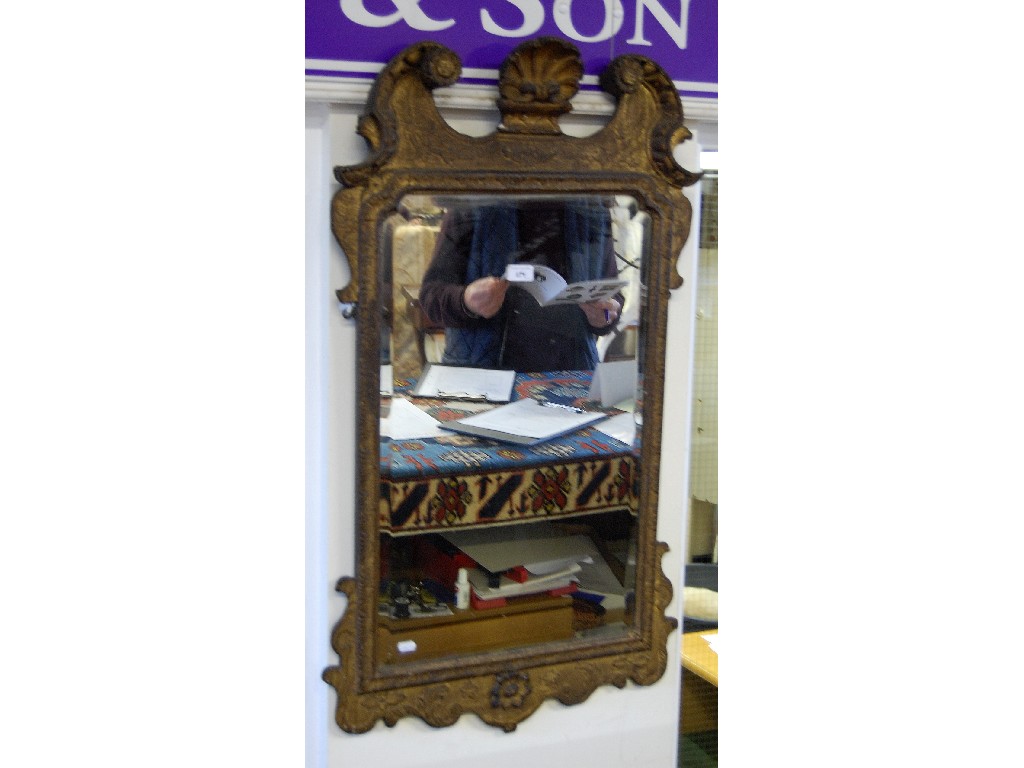 Appraisal: A Georgian gilt gesso wall mirror with bevelled plate surmounted