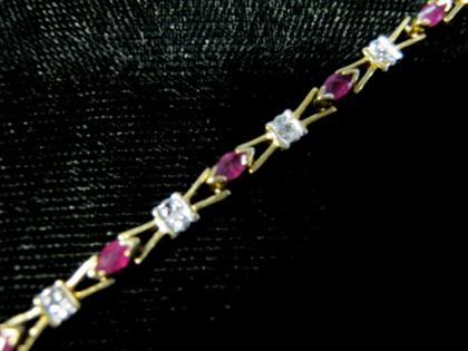 Appraisal: Yellow gold ruby and diamond flexible braceletLink style set with