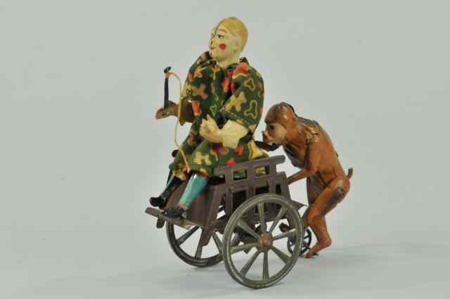 Appraisal: CLOWN ON CART PUSHED BY MONKEY Germany interesting toy depicts