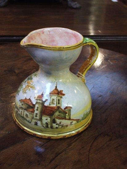 Appraisal: AN ITALIAN MAIOLICA POTTERY JUG with shaped handle and landscape