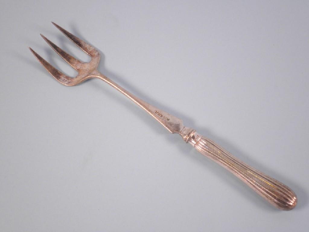 Appraisal: A silver toasting fork with a reeded shaped handle Sheffield