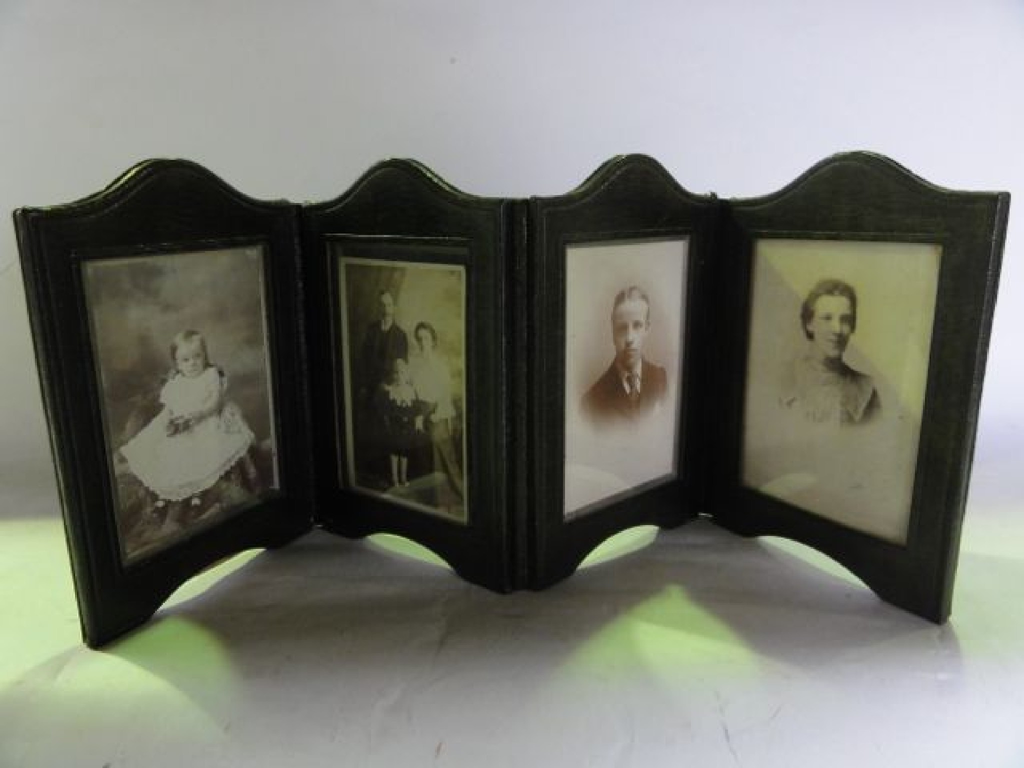 Appraisal: A four divisional Victorian green stained leather photo frame folding