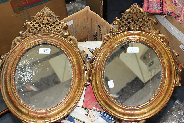 Appraisal: A PAIR OF OVAL GILT FRAMED MIRRORS with decorative fretwork