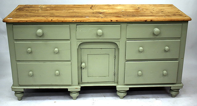 Appraisal: A PAINTED PINE DRESSER BASE the central panelled recessed cupboard