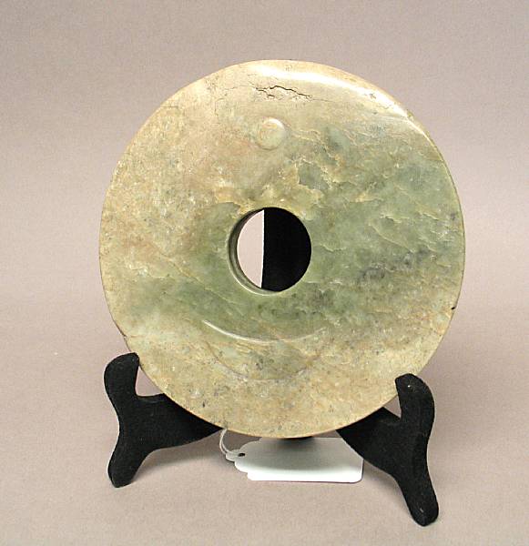 Appraisal: A carved nephrite bi disk Thickly sectioned and unevenly finished