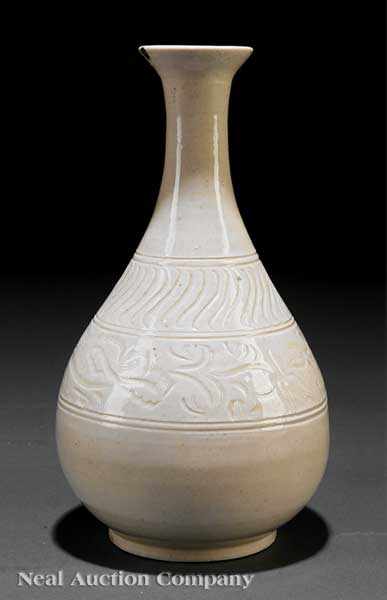 Appraisal: A Chinese Carved Xingyao or Dingyao Porcelain Bottle Vase probably