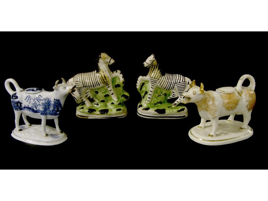 Appraisal: Pair of Staffordshire figures modelled as zebras upon oval shaped