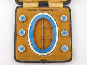 Appraisal: A silver enamel belt buckle with a set of six