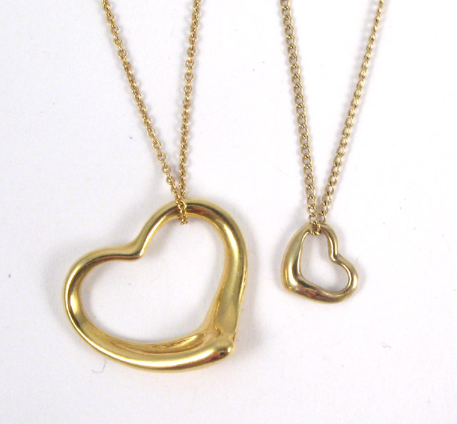 Appraisal: TWO YELLOW GOLD HEART PENDANT NECKLACES the larger is k