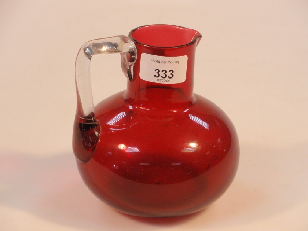 Appraisal: An early thC cranberry glass jug of compressed circular form