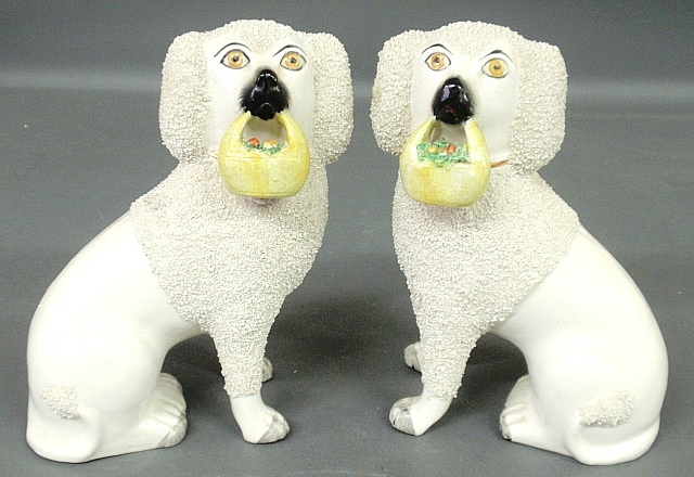 Appraisal: - Pair of Staffordshire seated white poodles c with flower