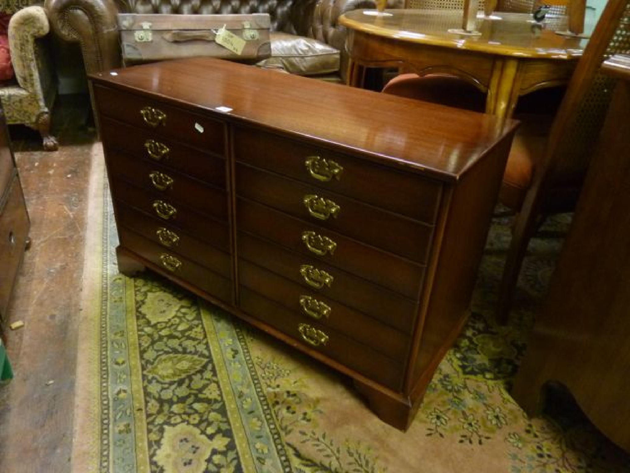 Appraisal: A contmporary mahogany chest of six short drawers in a