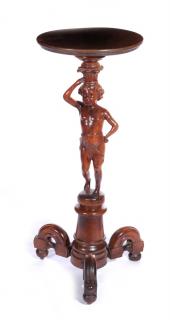 Appraisal: A CIRCA CARVED PUTTO FIGURAL PLANT STAND The circular top