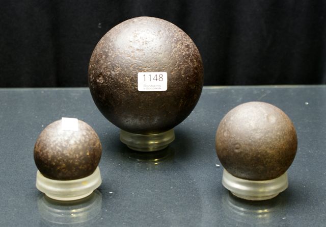 Appraisal: Three cannon balls with stands