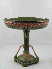 Appraisal: A ceramic Art Nouveau oval centrepiece in green with red