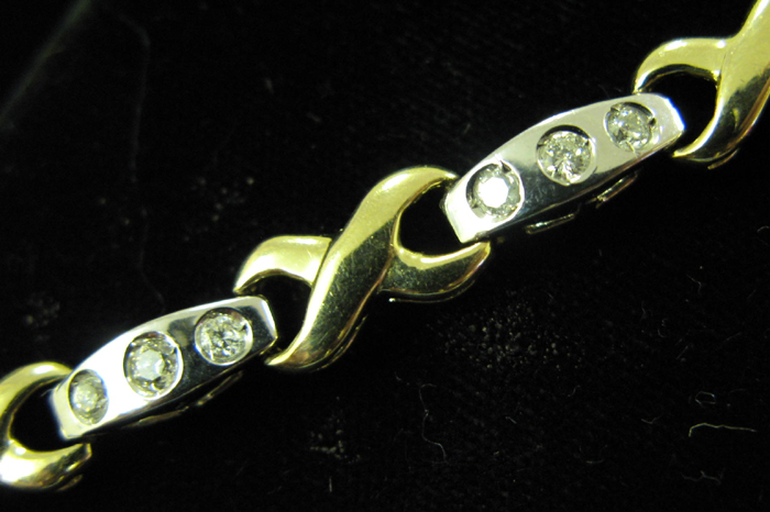 Appraisal: DIAMOND AND FOURTEEN KARAT WHITE AND YELLOW GOLD BRACELET The