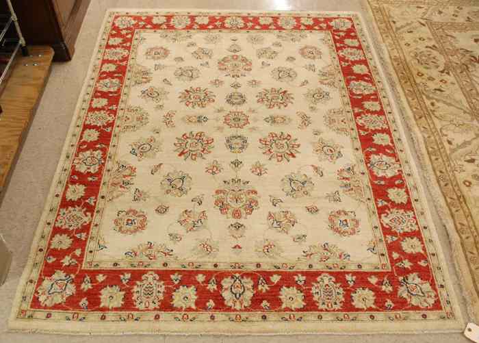 Appraisal: HAND KNOTTED ORIENTAL AREA RUG Pakistani-Persian overall floral design on