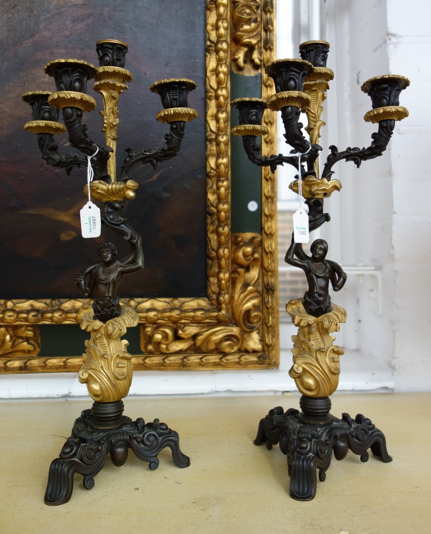 Appraisal: A pair of patinated and gilt bronze four branch figural