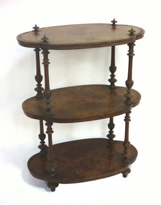 Appraisal: A Victorian walnut whatnot the three shaped oval tiers united