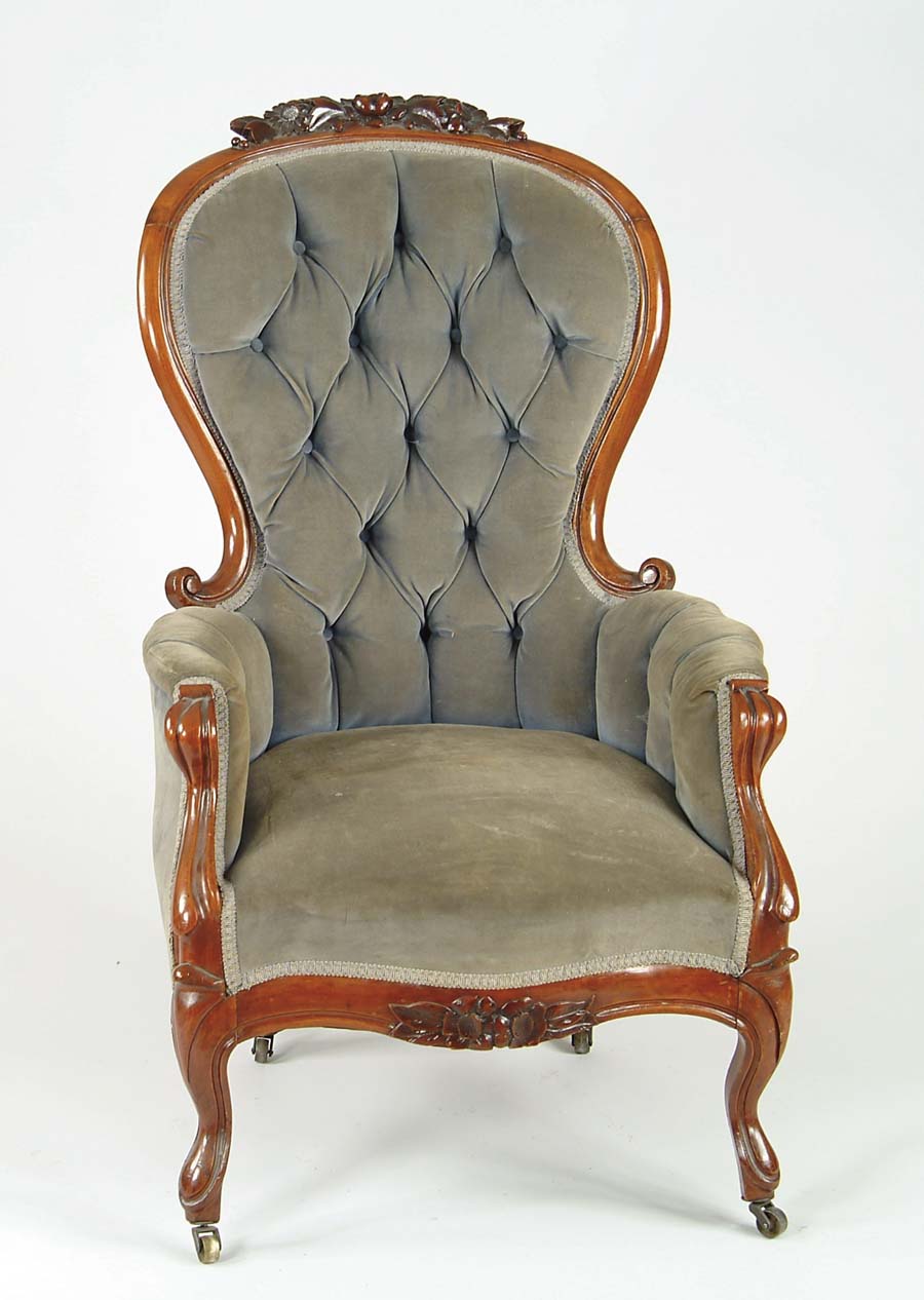 Appraisal: WALNUT VICTORIAN UPHOLSTERED GENT S CHAIR Flower carved crest and