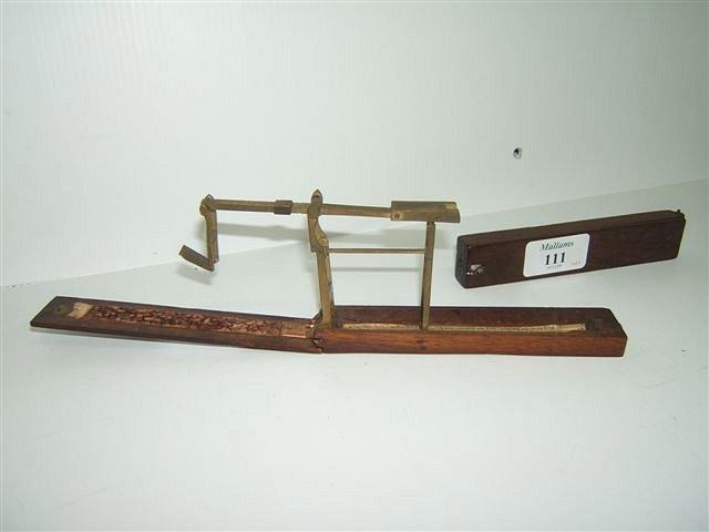 Appraisal: A GEORGIAN MAHOGANY AND BRASS FOLDING GUINEA SCALES with paper