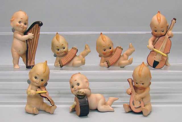 Appraisal: Lot of bisque Kewpie type musicians - Figurines playing drum