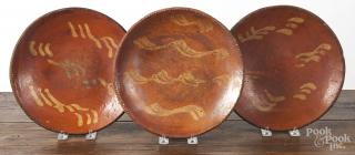 Appraisal: Three Pennsylvania redware plates th c with yellow slip decoration