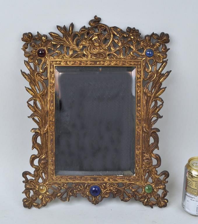 Appraisal: Bradley Hubbard Gilt Metal Foliate Mirror with faceted glass corner