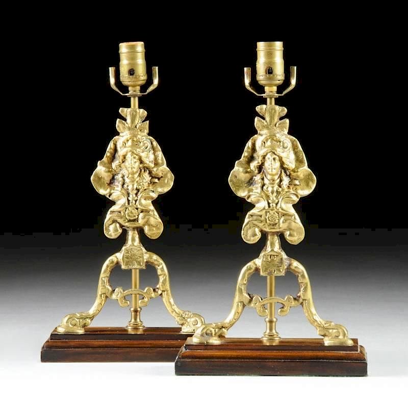 Appraisal: A PAIR OF REGENCE REVIVAL POLISHED BRASS CHENET FORM LAMPS