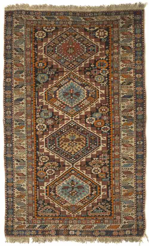 Appraisal: Caucasian throw rug with four medallions and multiple borders with