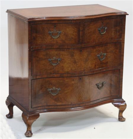 Appraisal: A walnut serpentine chest the crossbanded moulded top over two