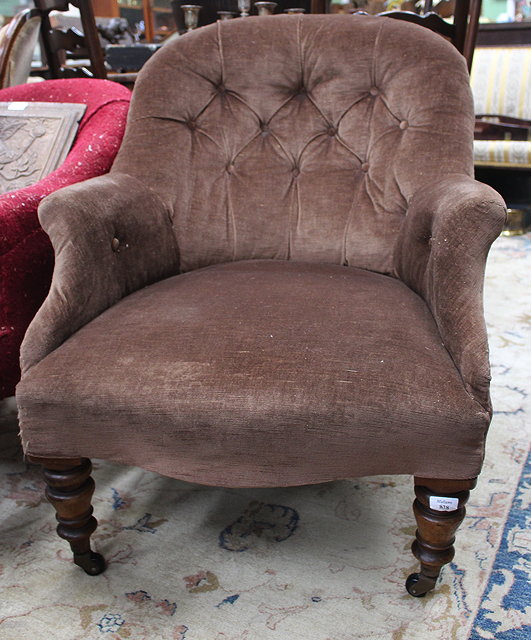 Appraisal: A VICTORIAN BROWN BUTTON UPHOLSTERED TUB ARMCHAIR standing on ring