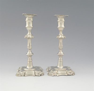 Appraisal: A pair of early George III cast candlesticks on shaped