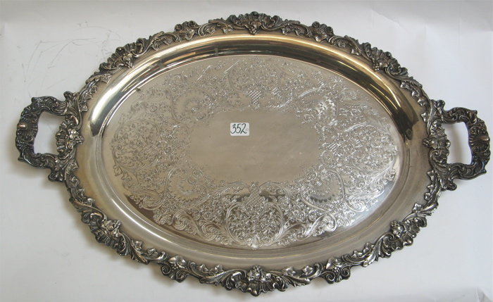 Appraisal: TWO SILVER PLATED SERVING TRAYS ornately chased and engraved with