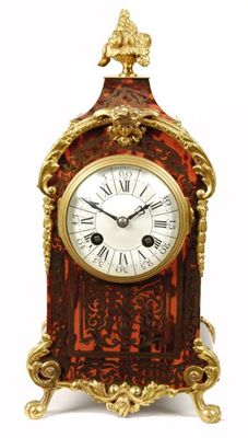 Appraisal: A French tortoiseshell and cut brass mantel clock with an