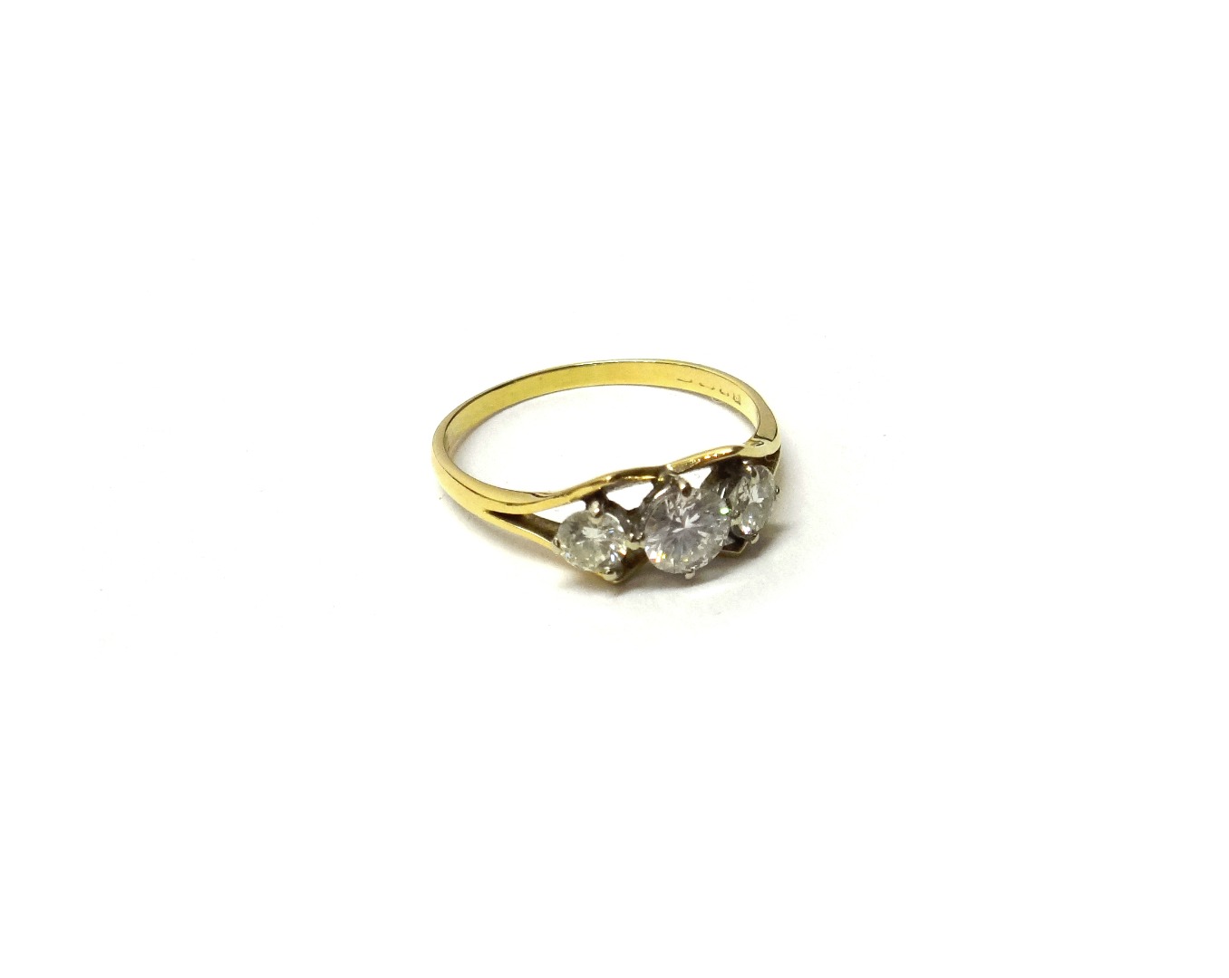 Appraisal: A gold and diamond set three stone ring claw set