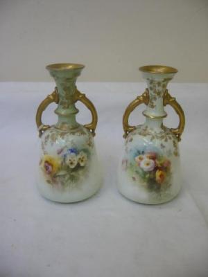 Appraisal: A PAIR OF DOULTON PORCELAIN VASES of shouldered tapering form