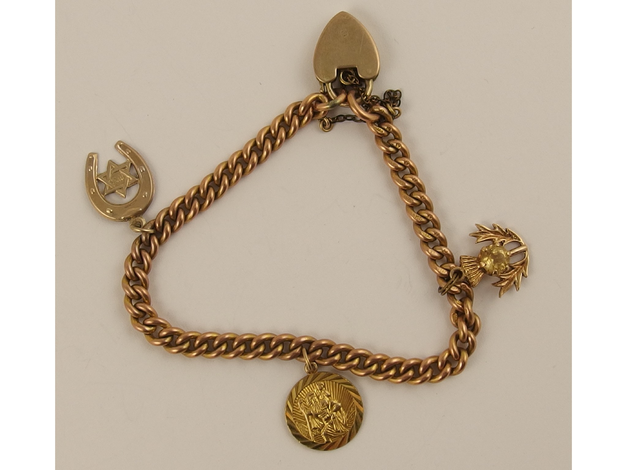 Appraisal: A ct curb chain bracelet with three ct charms weight