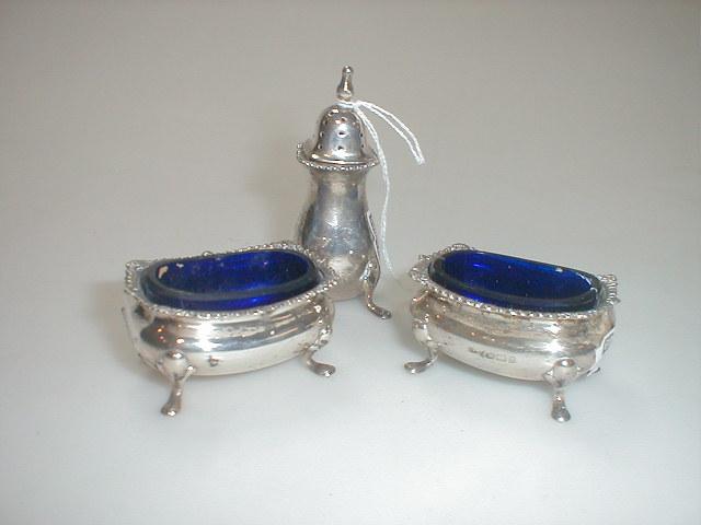 Appraisal: A George V silver three piece cruet set comprising a