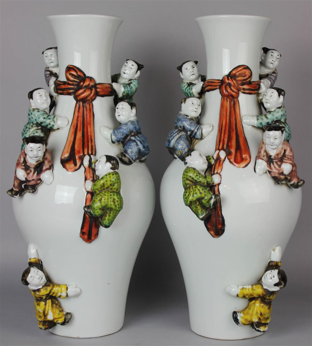 Appraisal: PAIR OF CHINESE BALUSTER VASES MOLDED WITH CLIMBING CHILDREN the