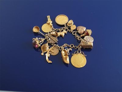 Appraisal: A gold charm bracelet The ct gold bracelet mounted with