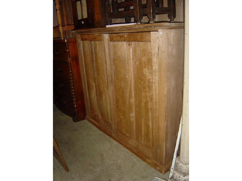 Appraisal: A Victorian pitch pine side cupboard enclosed by a pair