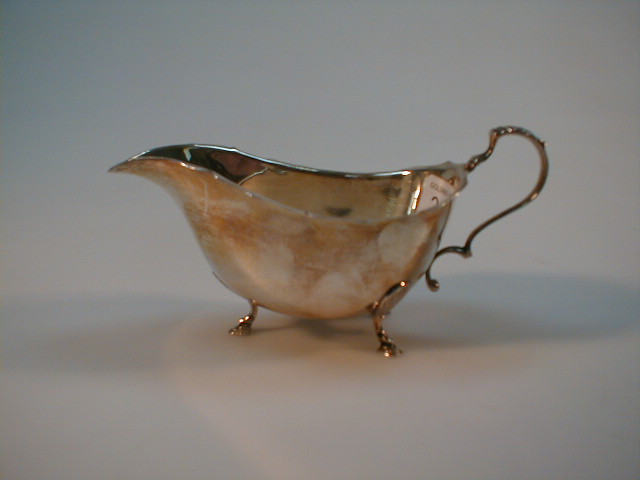 Appraisal: A Georgian style silver sauce boat Birmingham assay