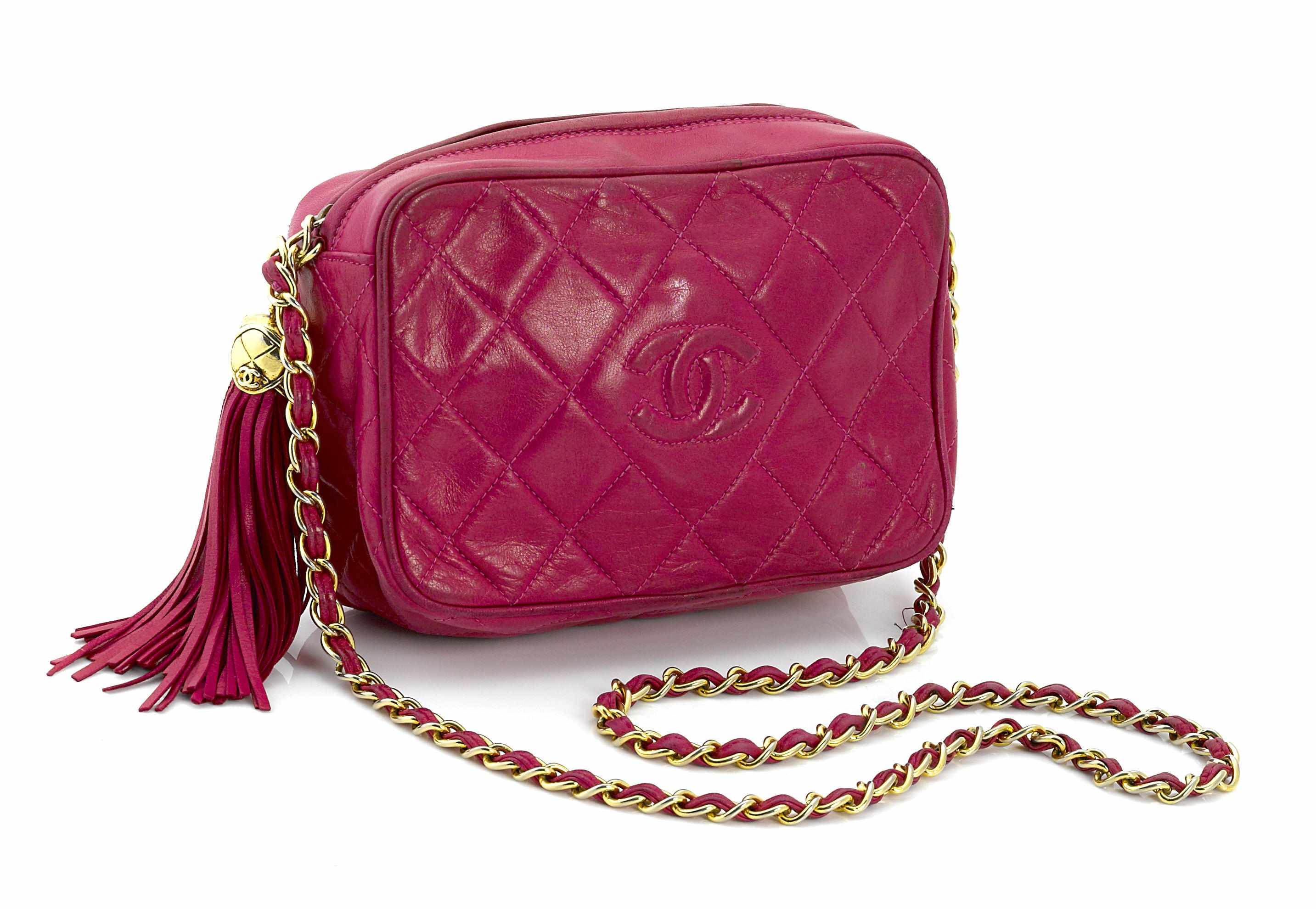 Appraisal: A Chanel fuchsia camera handbag with tasseled zipper pullsize in