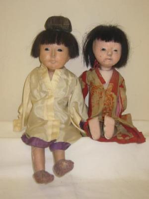 Appraisal: Two composition Japanese dolls with fixed brown glass eyes black