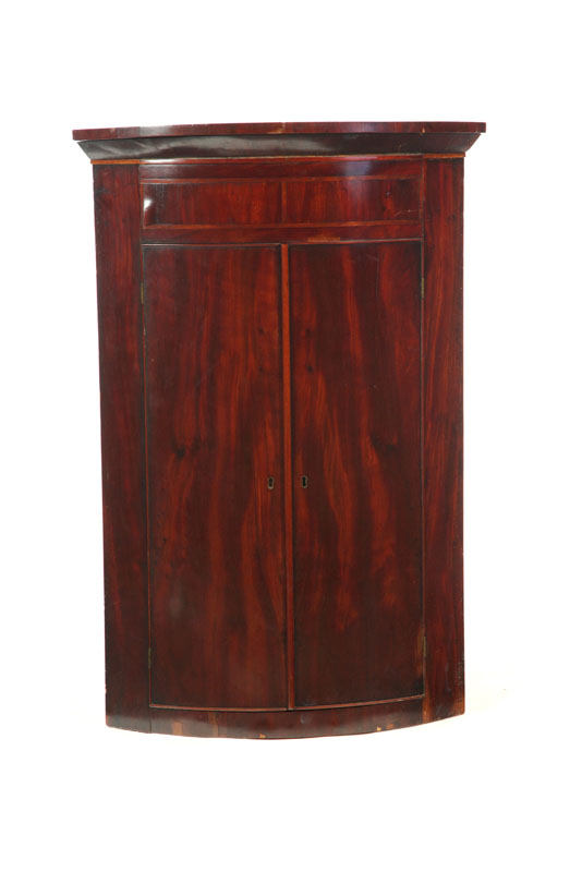 Appraisal: REGENCY HANGING BARREL-FRONT CORNER CUPBOARD England th century mahogany veneer